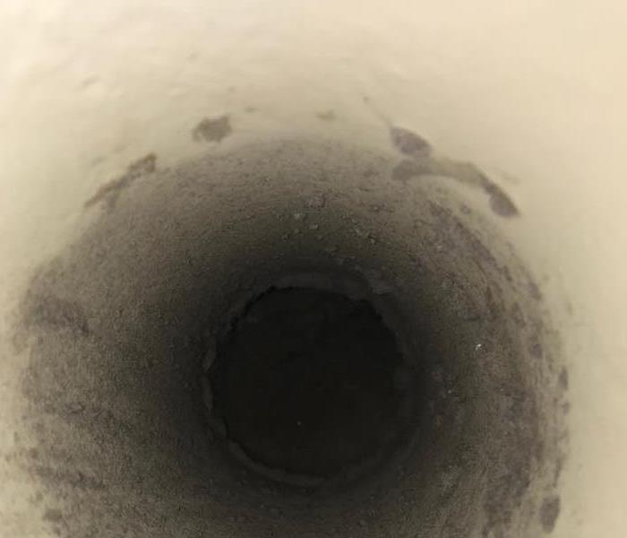Dryer vent covered in lint and dust. 