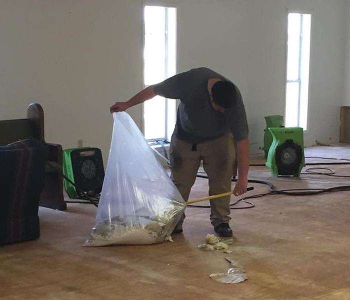 SERVPRO Employee cleaning debris from sub floor
